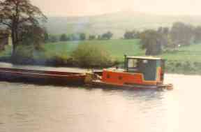 Bantam 4 pushing a flat barge on the Kennet and Avon