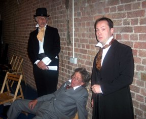 Actors in costume against a background of natural brick