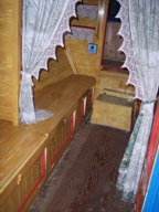 Boat canin framed by lace curtains, yellow wood