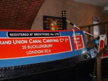 The red cabin side of narrowboat with mock arch above