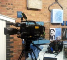 Large camera in front of exhibits