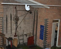 An range of tools and weighing balances against a brick wall background