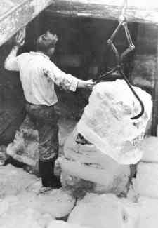 Man lifting the ice with large tongs