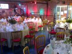 Red and blue lights on wall, tables in front
