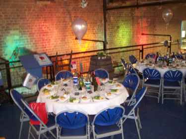 coloured lights focus on wall, tables foreground