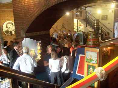people chatting underneath the scenic arch surrounded by exhibitions