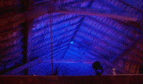 Pitched timber roof lit with changing colours