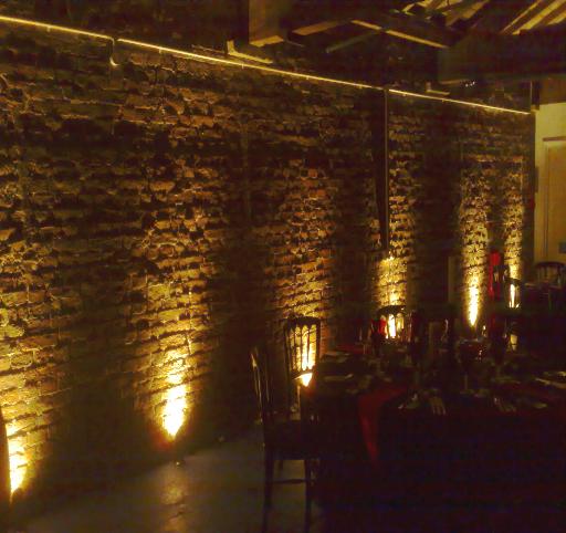 Brick wall lit by several uplighters