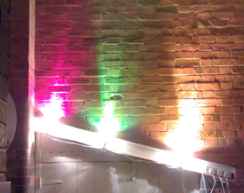 3 spotlights point up on brick wall